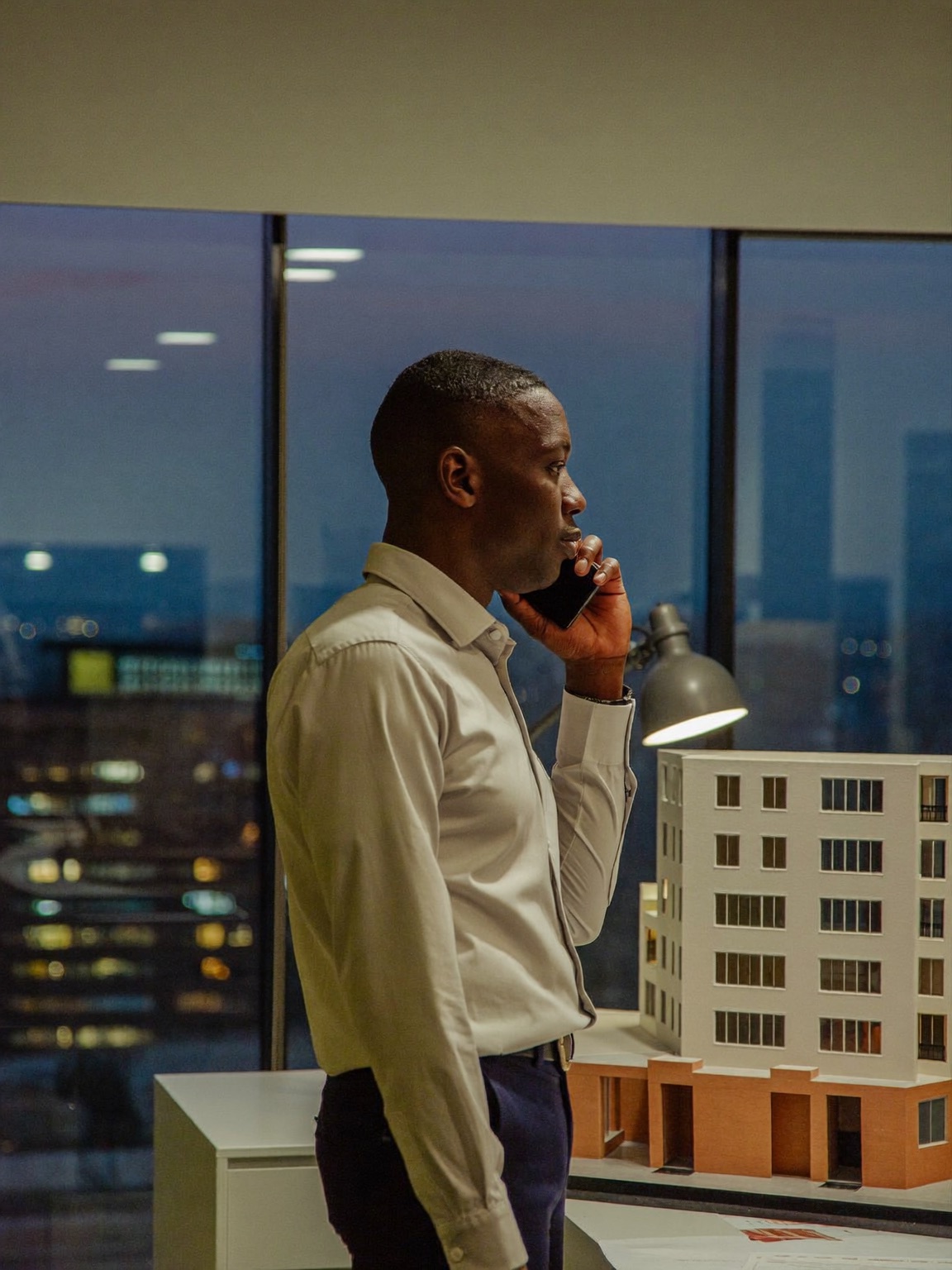 Property advisor on a call at dusk