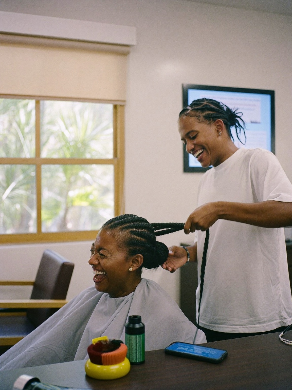 Stylist braiding a client's hair